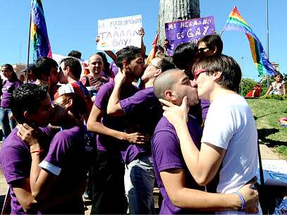 Casais gays se beijam em protesto para lembrar o Dia Internacional Contra a Homofobia, na pra�a das Armas, em Assun��o, no Paraguai. A data de combate � viol�ncia e discrimina��o contra homossexuais foi celebrada com protestos em v�rias cidades do mundo. Foto: AFP