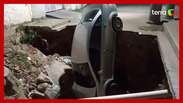 A car falls into the crater of an unsigned construction site in Baixada Fluminense