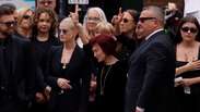 Ozzy Osbourne's widow is supported by her children during the musician's funeral