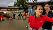 Relatives of the victims of the operation kneel in an avenue to ask for the bodies to be released in Rio