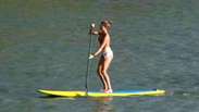 Grazi Massafera faz stand up paddle na praia e brinca com fãs