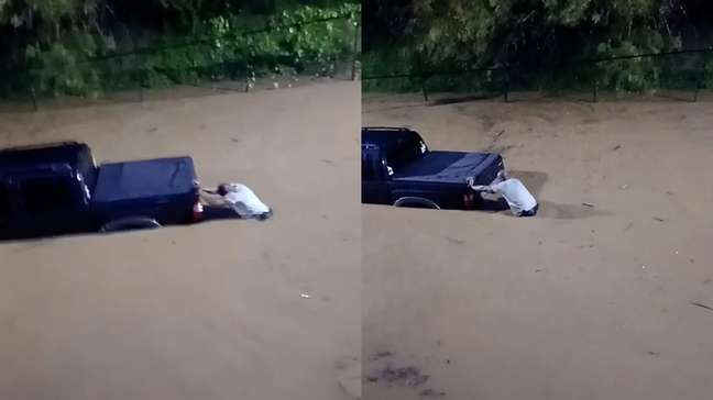 Homem se arrisca em rua alagada para tentar salvar carro de enchente em Juiz de Fora (MG)